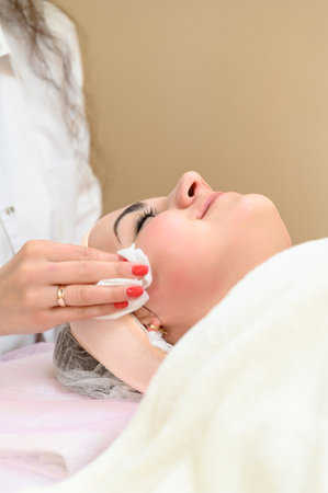 The procedure of washing a girl by a cosmetologist before or after the procedure, cosmetology officeの写真素材