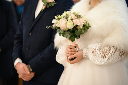 Bouquet for the bride in the hands of the grooms close-up, fresh flowers for the bouquet.の写真素材