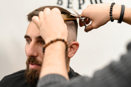Haircut and alignment of the contour of the head with scissors. Short haircut in the barbershop.の写真素材