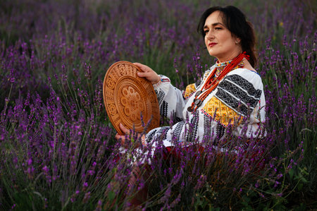 Ivano-Frankivsk, Ukraine August 14, 2023: a woman conveys all Ukrainian ethnicity and style, a woman holds a carved plate in her hands.のeditorial素材