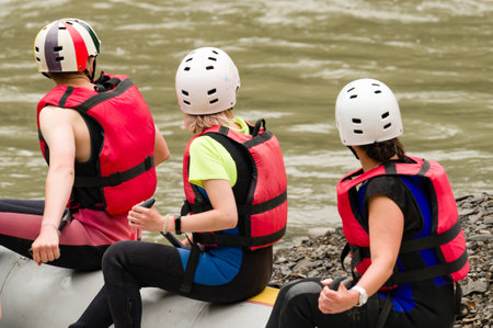 People prepare for rafting, mountain rafting for tourists. The athlete is waiting for the team on the bank of the river.の写真素材