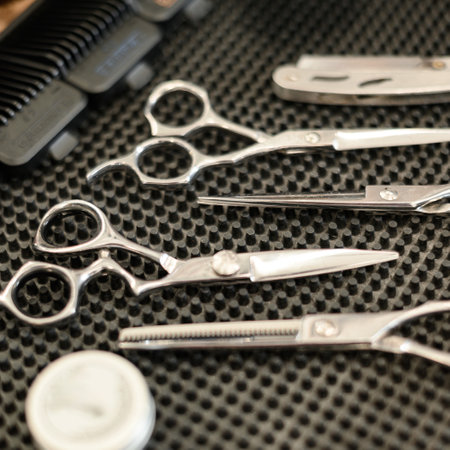 Barbers tools for mens haircuts laid out on a table close up. Set of scissors for haircuts.の写真素材