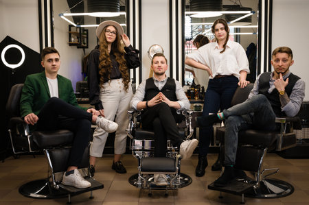 Five hairdressers stylists boys and girls after work. Portrait of a professional barbershop team.の写真素材