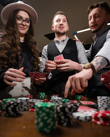 Ivano-Frankivsk, Ukraine February 23, 2024: Five young people play poker and drink Jack Daniels.のeditorial素材