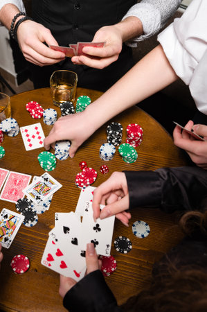 First-person observation of card poker from various close-up angles. A team of young boys and girls play poker.の写真素材