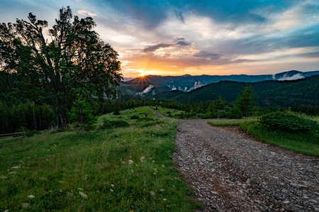 Magical dawn in the Carpathians, in the foreground a road for tourists, fabulous dawns in the mountains.の写真素材