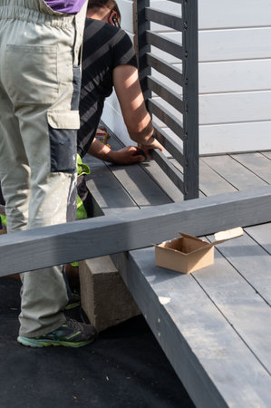 Alignment and screwing of wooden gazebo components, installation work on garden gazebos.の写真素材