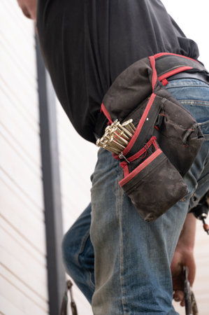 A work belt with pockets for carpentry tools on the worker's waist, a convenient work equipment for a carpenter.の写真素材