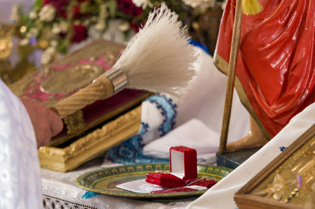 Religious ceremony with a small red box and a ceremonial brush.の写真素材