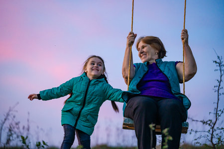 A heartwarming scene of intergenerational connection. A grandmother and her granddaughter enjoy a...