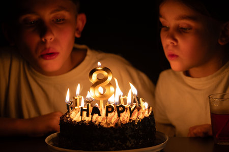 Two excited children gaze intently at a beautifully decorated birthday cake adorned with an 8...