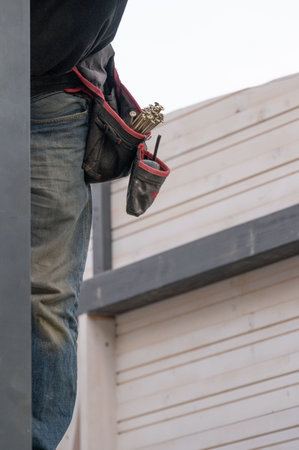 A work belt with pockets for carpentry tools on the worker's waist, a convenient work equipment for a carpenter.の写真素材
