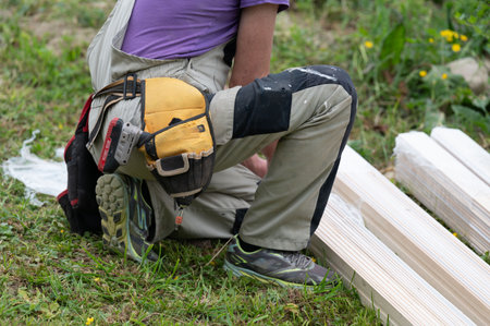Worker unpacks white boards for building a gazebo, installation work.の写真素材