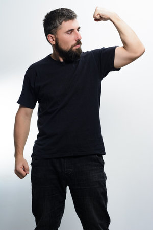 Man flexing bicep, showing strength.