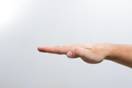 Open hand gesture on a plain backgroundの写真素材