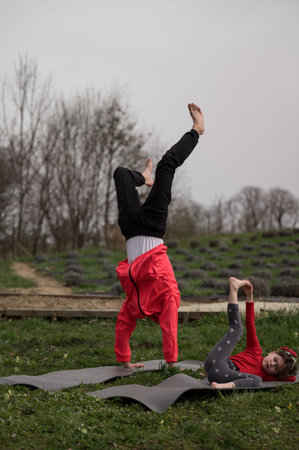 Two children engage in playful exercise, showcasing their flexibility and energy on yoga mats set...