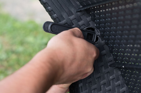 Assembling outdoor furniture with a simple tool.  Easy setup for relaxing comfort.の写真素材