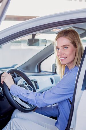 Beautiful young woman in carの写真素材