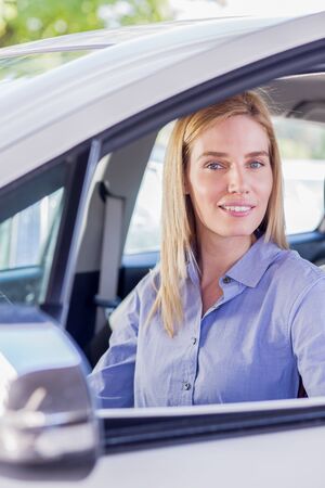 Beautiful young woman in carの写真素材