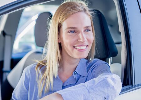 Beautiful young woman in carの写真素材