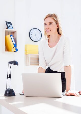 Beautiful young woman in officeの写真素材