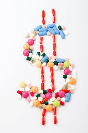 Pills and tablets on white background with dolar symbol in vivid colorsの写真素材