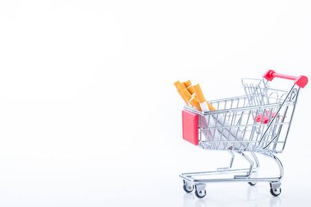 Cigarettes in shopping cart, isolated on white background,Cigarettes in supermarket trolleysの写真素材