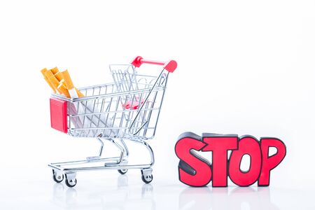 Cigarettes in shopping cart, isolated on white background,Cigarettes in supermarket trolleysの写真素材