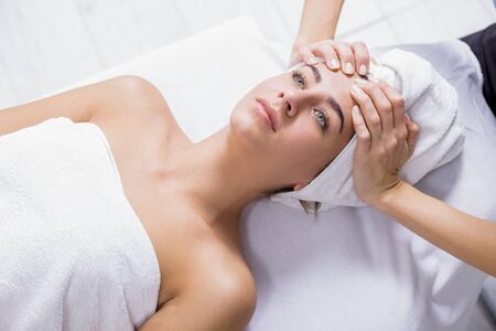 Young woman enjoying facial massage at spa salon.Facial massageの写真素材