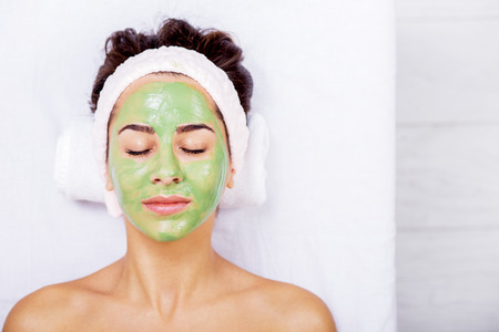 Young woman in a spa with algae facial mask. Woman in spa salonの写真素材