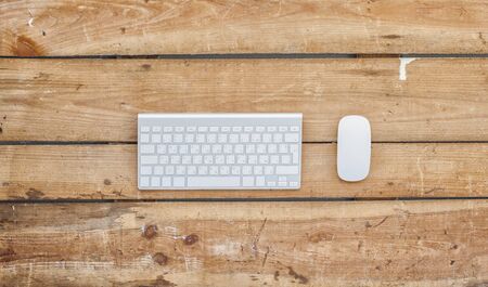 Business concept photo. Modern keyboard and mouse vintage old wooden background.の写真素材