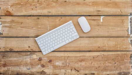 Business concept photo. Modern keyboard and mouse vintage old wooden background.の写真素材