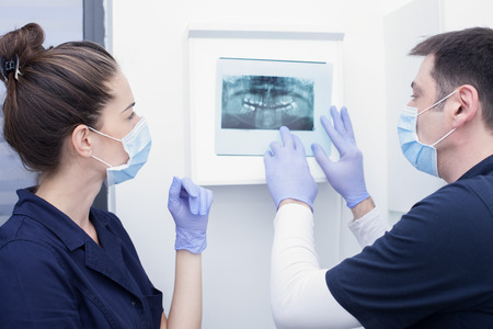 Dentist and assistant examining x-ray togetherの写真素材