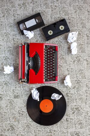 Equipment single journalists. Old typewriter, crumpled paper, video tapes, cassettes and beta dv tapes on the vintage background. The old conceptの写真素材