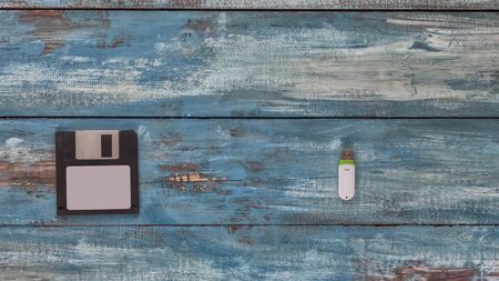 Floppy disk and usb flash storage on vintage wood boardの写真素材