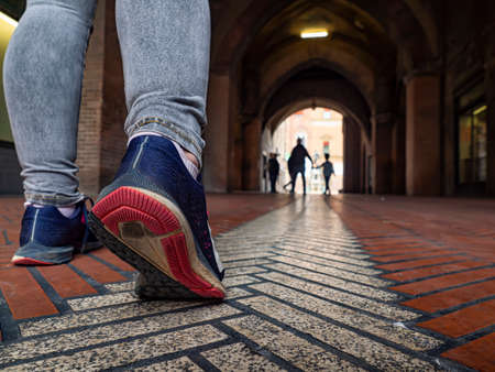 Female leg on an alleyway of Bolognaの写真素材