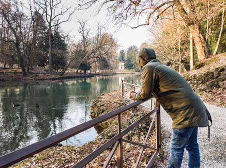 Man on the lakeside of the lake of Villa Reale in Monzaの写真素材