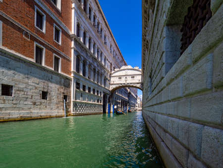 Typical canal of Venice with gondoliersの写真素材