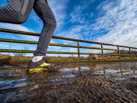 Running on a muddy trailの写真素材