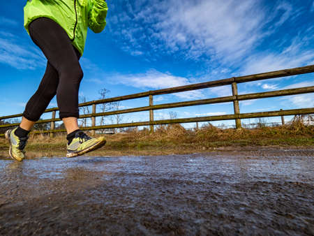 Running on a muddy trailの写真素材