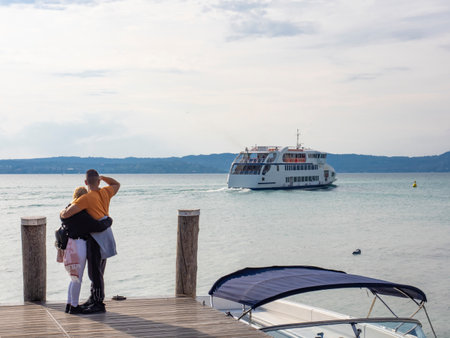 Couple watching the landscape of lake Gardaの写真素材