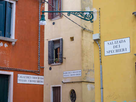 Typical alleyway of Venice with the names of the roads on the wallの写真素材