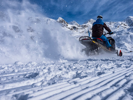 Snowmobile on a trail in the Italian alpsの写真素材