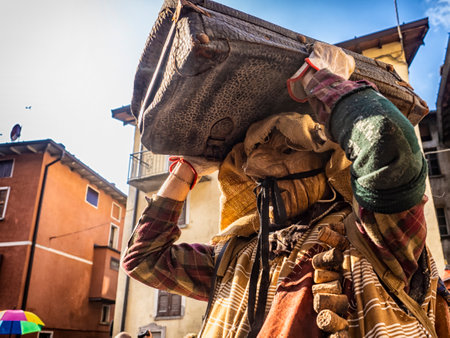 Shignano (Italy) 21/02/2023: The carnival of Schignano parade is one of the most famous traditional carnivals of north Italy with typical wood masks and performer that entertain the visitors .の写真素材