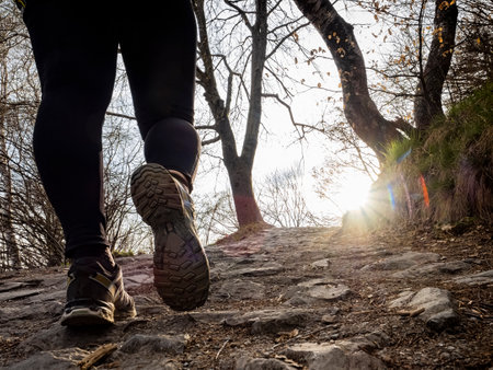 Walking scene on a mountain trail at sunsetの写真素材