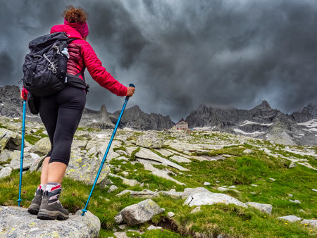 Trekking scene in the italian alps of Val Masino during a stormの写真素材