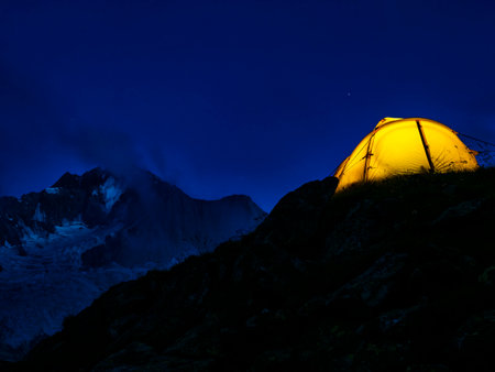 Camping tent at night in the Italian Alpsの写真素材