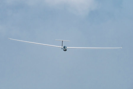 Glider plane flying in the cloudsの写真素材