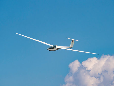 Glider plane flying in the cloudsの写真素材