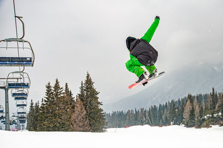 Snowboarder on a slope in the alpsの写真素材
